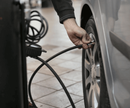 Man inflating a tire - tire inflation services for low tire pressure