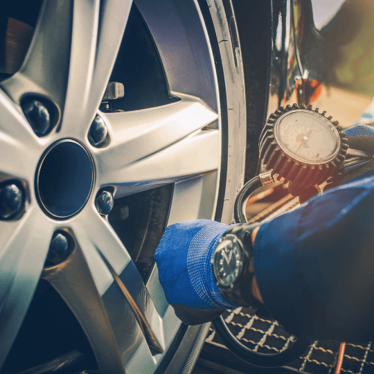 Mechanic checking tire pressure