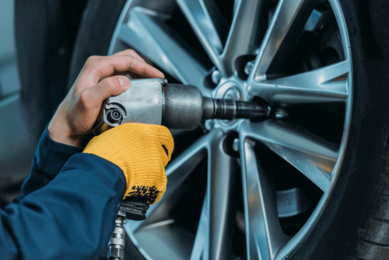 Local mechanic putting a new tire on a vehicle