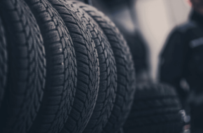 Four tires lined in a row, meant to represent different tire seasons