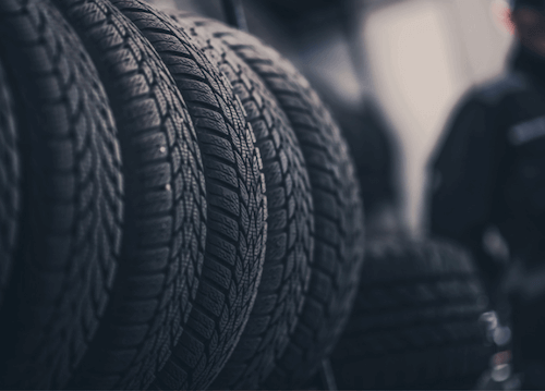 Four tires lined in a row, meant to represent different tire seasons