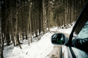 A car driving on a snow-covered road in the winter