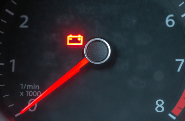 a car battery warning light on a dashboard
