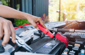 person jumping a car battery