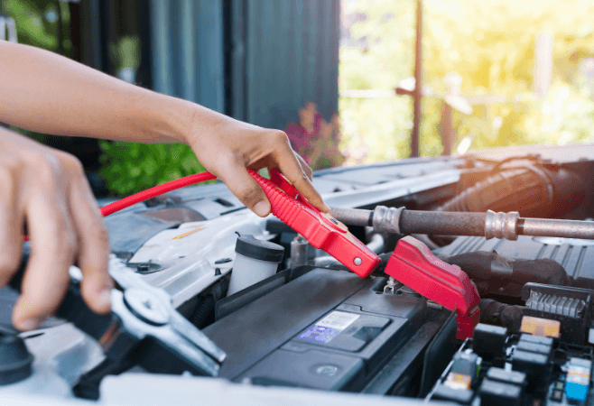 person jumping a car battery