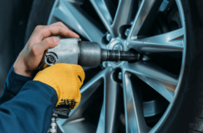 Mechanic changing a tire with a wheel lock key