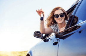 woman holding car keys out the window