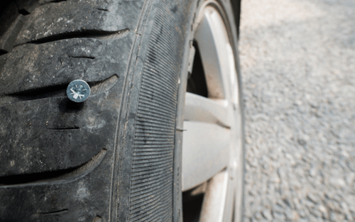 Picture of a screw puncturing a tire