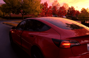 Tesla driving at sunset