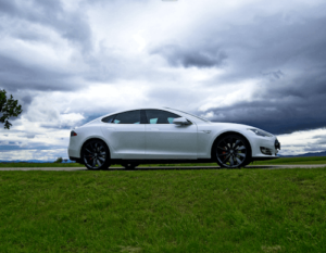 Tesla driving on a field of grass