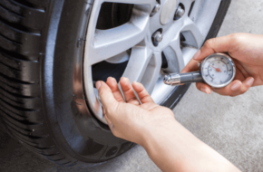 Mechanic checking for low tire pressure