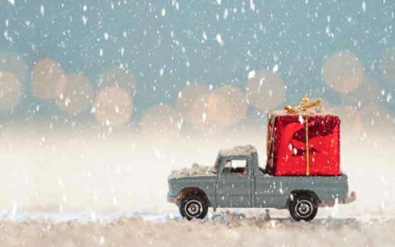 Toy car carrying an oversized gift