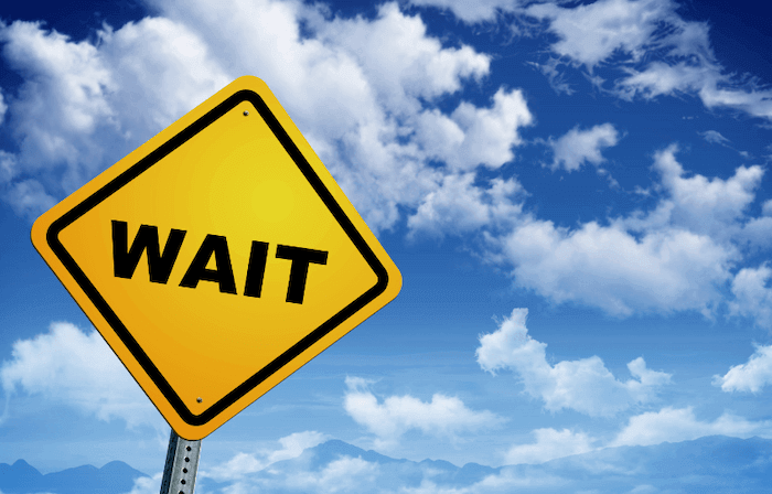 Road sign edited to say "wait"