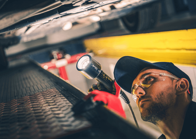 mechanic performs a pre-purchase vehicle inspection