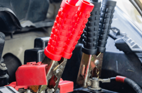 Jumper cables attached to a vehicle's battery