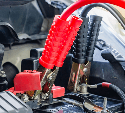 Jumper cables attached to a vehicle's battery