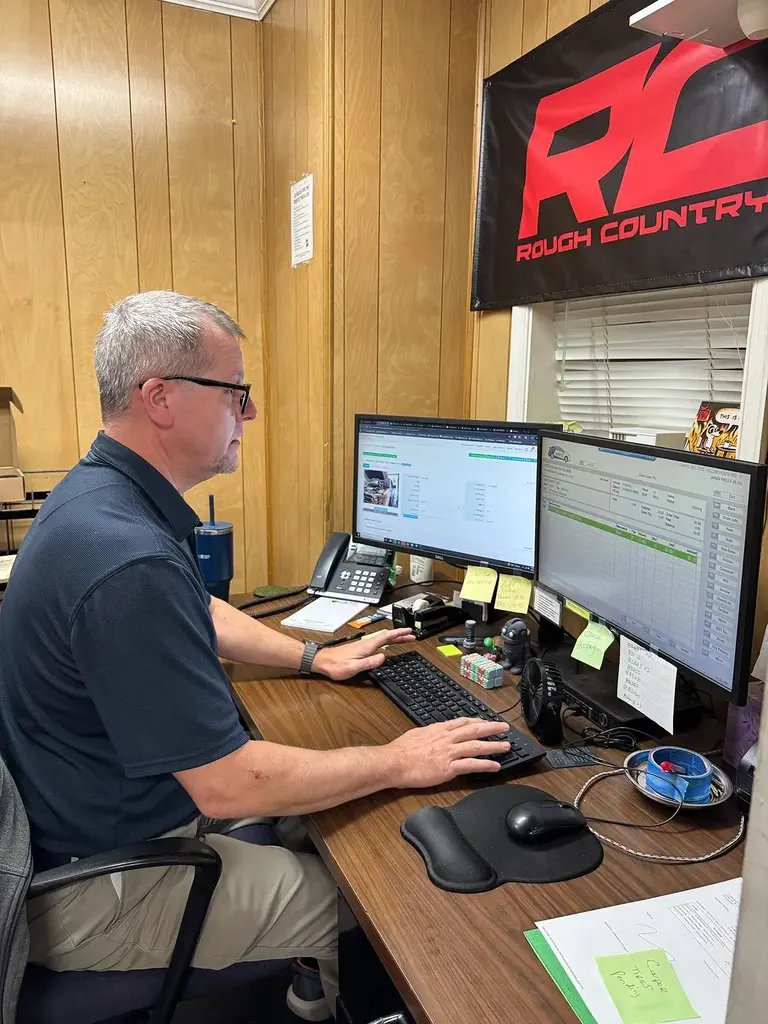 Man working at dual-monitor office desk