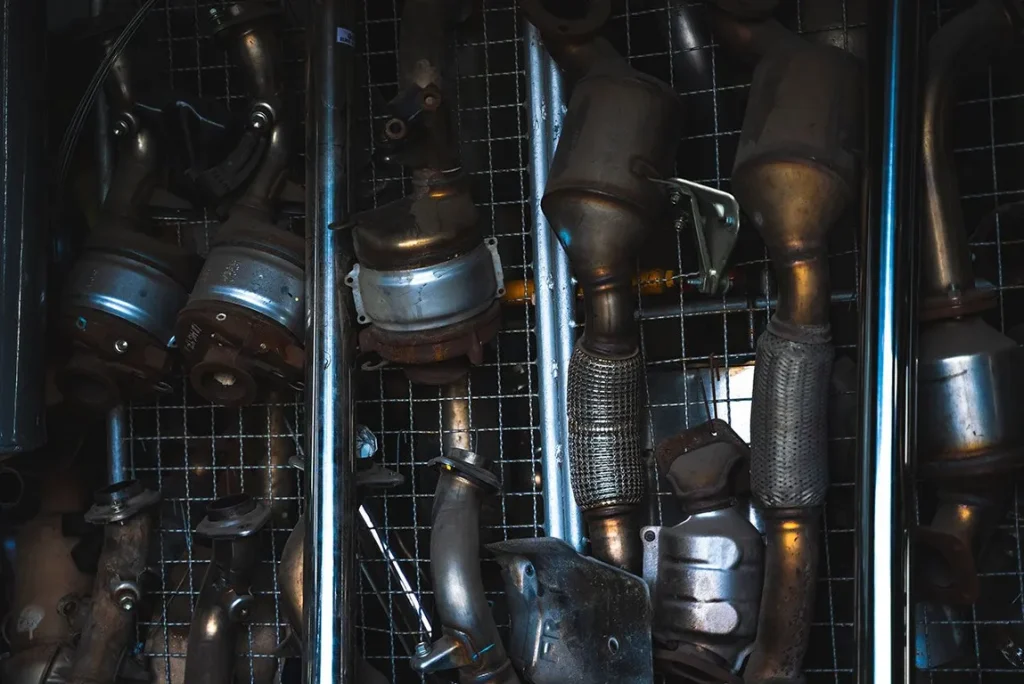 Used car exhaust pipes and catalytic converters hanging