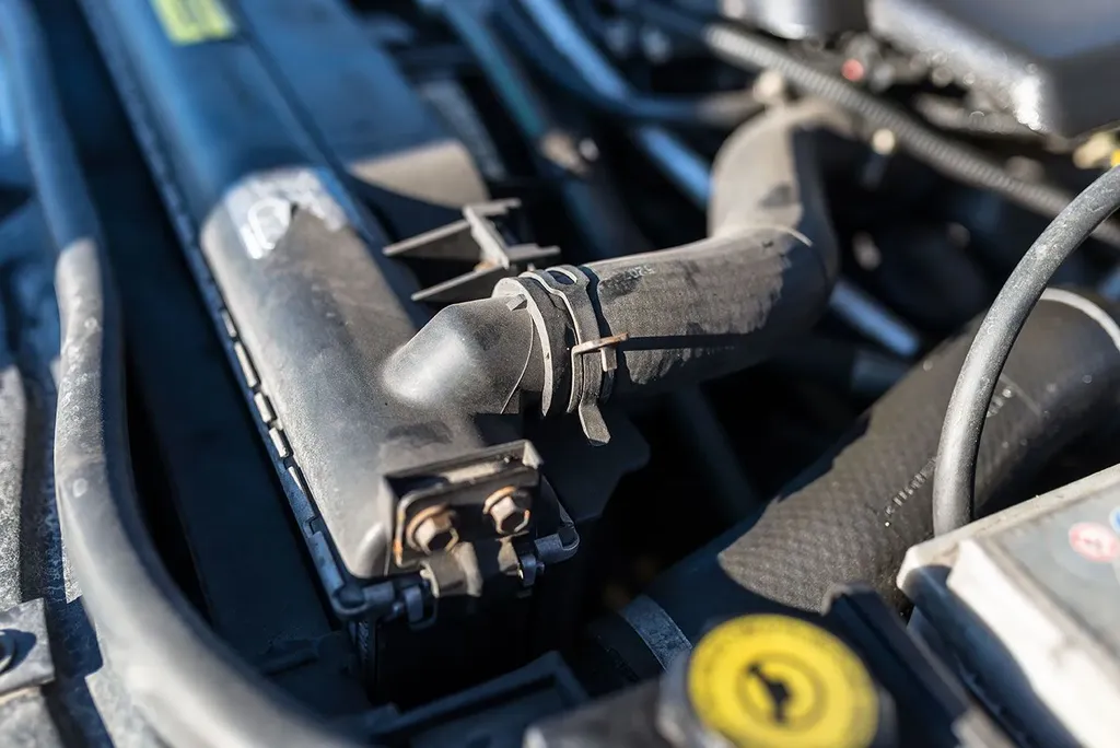 Close-up of car engine air intake hose and housing