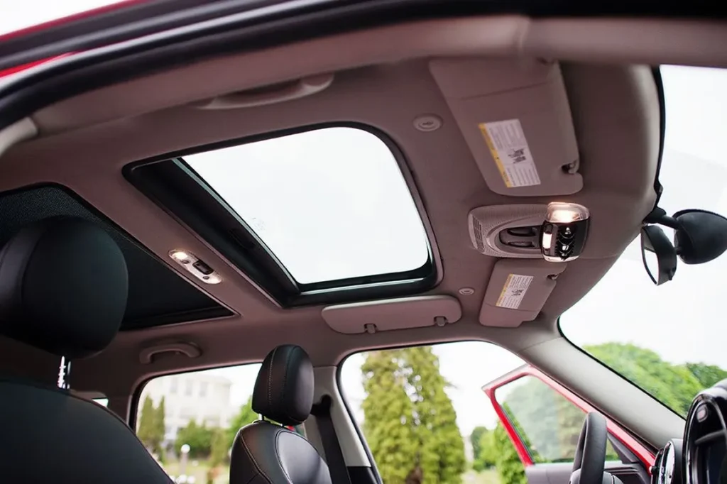 Car interior with panoramic sunroof and open door