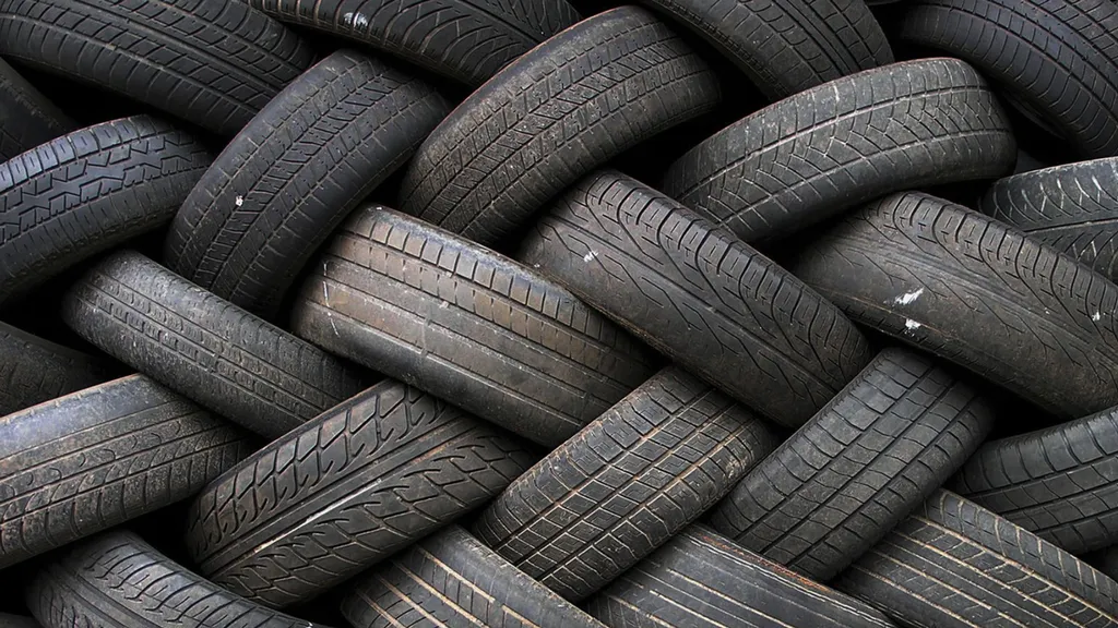 Pile of worn black vehicle tires with visible tread patterns